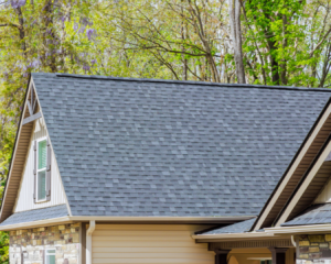 Beautiful residential home with new asphalt shingles on a bright, sunny day.