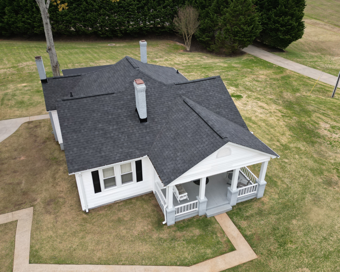 Aerial view of beautiful white home with new asphalt roof by Southern Shingles.